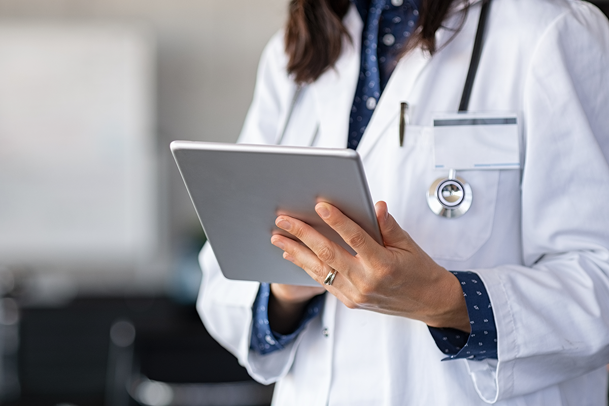 image of a medical professional working on a tablet